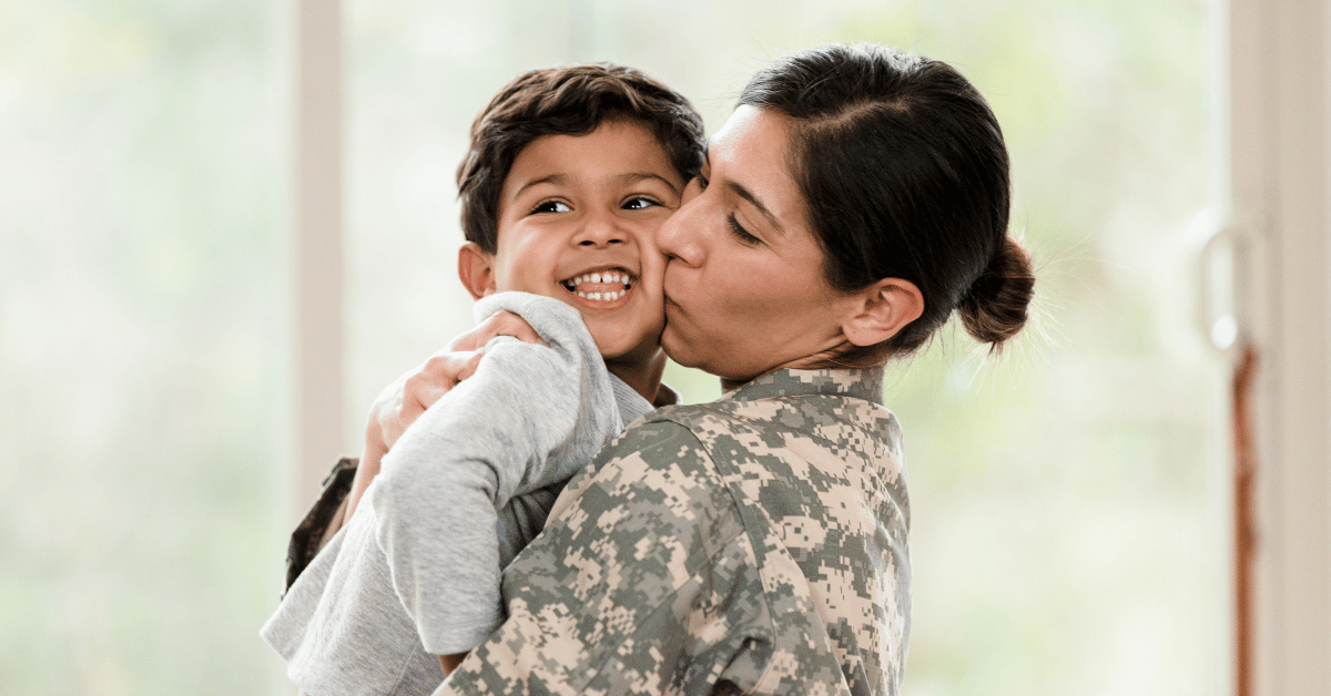phone, fintech notebook, and coffee cup on table, with a hand over the notebook with a pen.