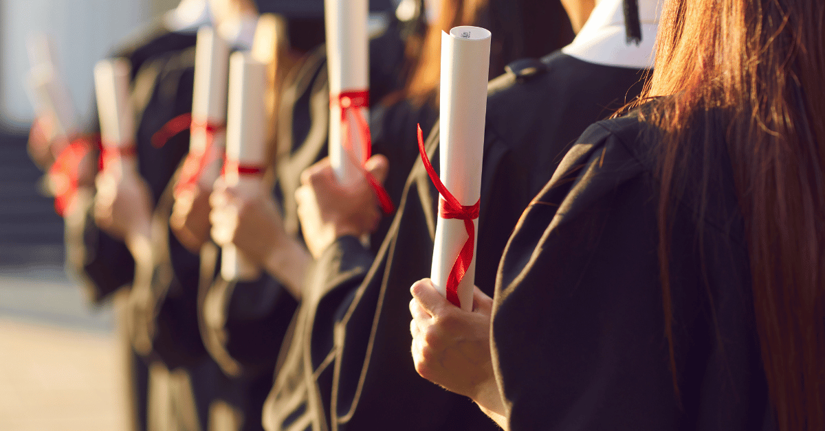 Fintech phone, fintech notebook, and coffee cup on table, with a hand over the notebook with a pen.