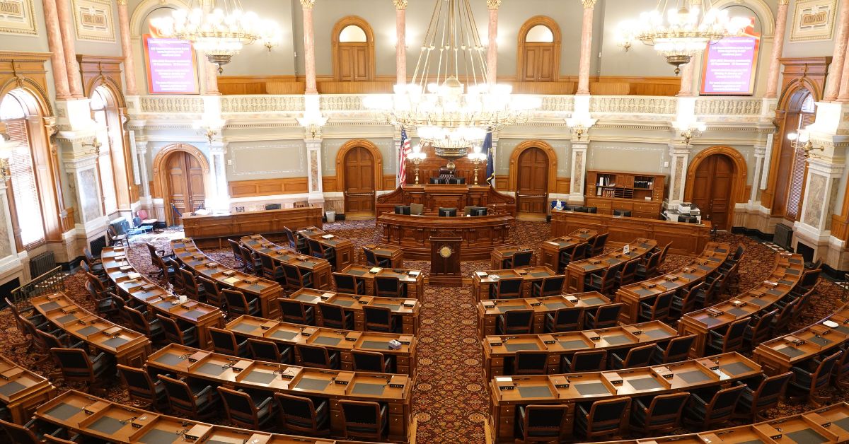 phone, fintech notebook, and coffee cup on table, with a hand over the notebook with a pen.
